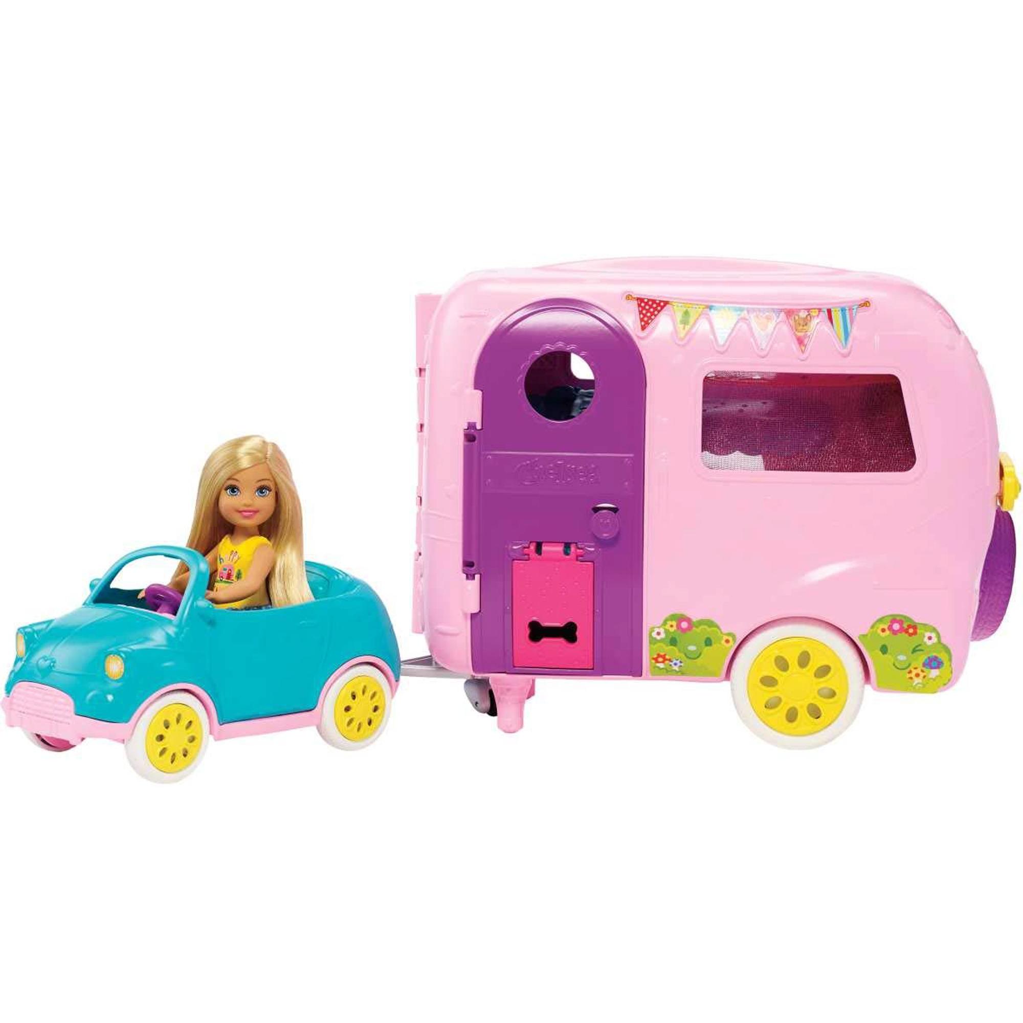 Bright pink camper playset with purple accents, featuring a toy car in teal, a blonde Chelsea doll, and decorative bunting, designed for imaginative play.