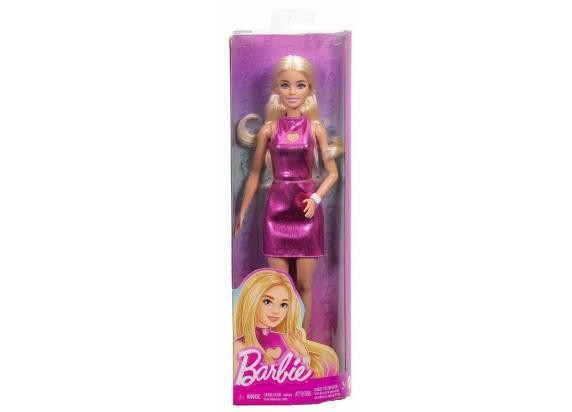 Barbie doll dressed in a metallic pink minidress with a heart cut-out, featuring long blonde hair and packaged in a clear box with a pink background.