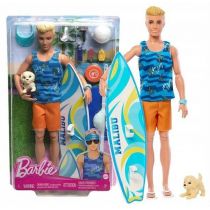 Ken doll features blonde hair, wearing a blue wave-patterned tank top and orange shorts, holding a surfboard and a small dog, with beach accessories in the packaging.