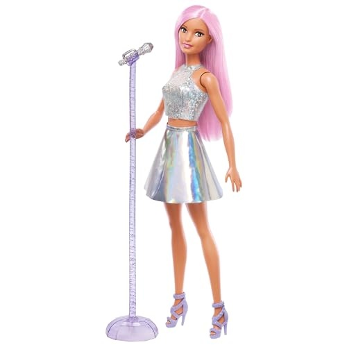 Barbie doll with long pink hair, wearing a sparkly silver crop top and iridescent skirt, stands beside a microphone on a stand, showcasing stylish accessories.