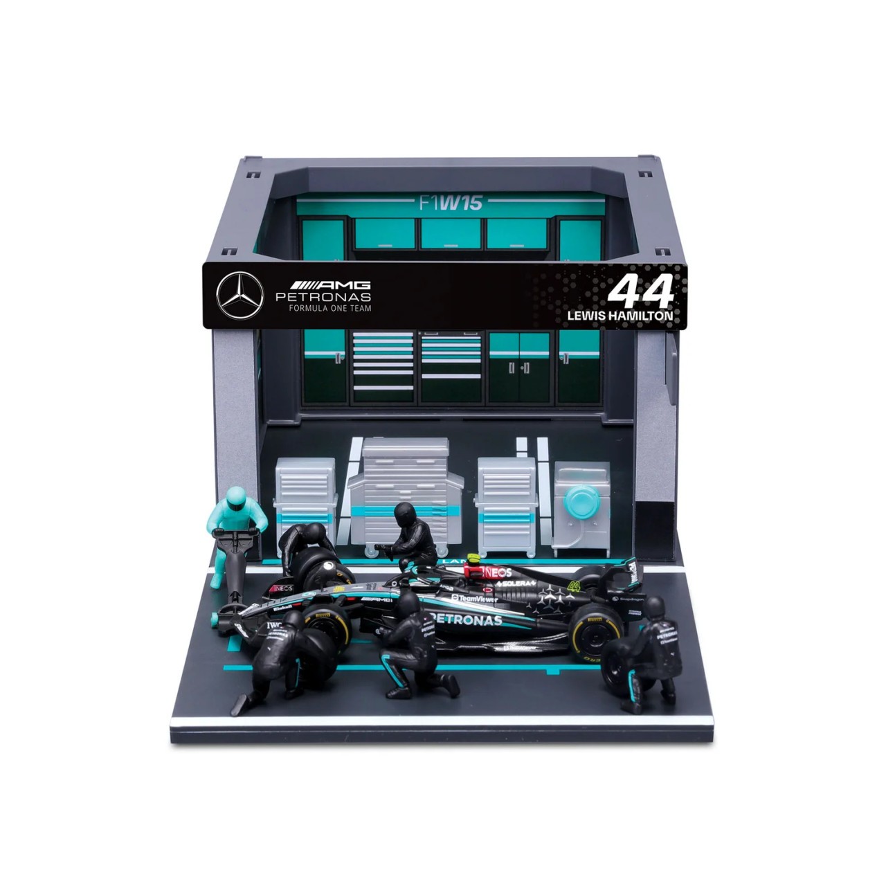 Bburago F1 Mercedes Pitt Pass 1:43 model featuring a detailed pit stop scene with a black and silver car, pit crew figures, and a garage backdrop with team branding.