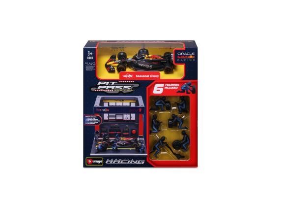 Red Bull Racing F1 car model in 1:43 scale, featuring a vibrant blue and red design, packaged with six pit crew figures and a detailed pit box backdrop.