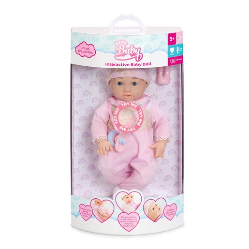 Interactive baby doll in a pink onesie with a bib, featuring a pacifier and a smiling face, displayed in a clear packaging with colorful accents and heart graphics.
