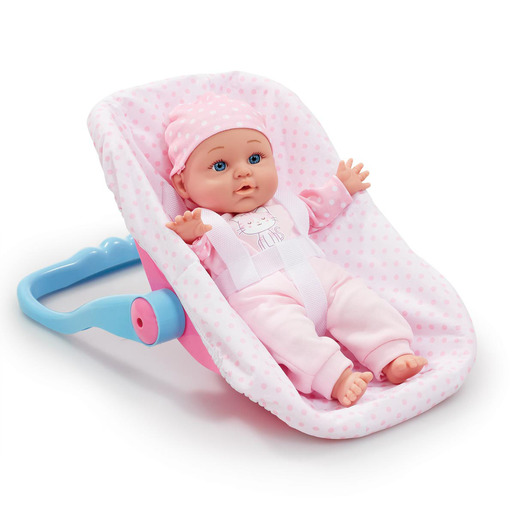A soft-bodied baby doll in pink pajamas and a matching hat, resting in a pink and blue bouncer with polka dots and a safety harness.