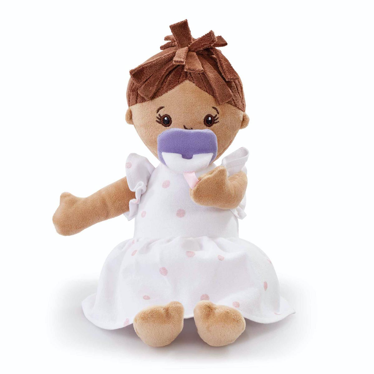 Soft baby doll with brown hair and a purple pacifier, wearing a white dress with pink polka dots, featuring plush arms and legs for cuddly play.