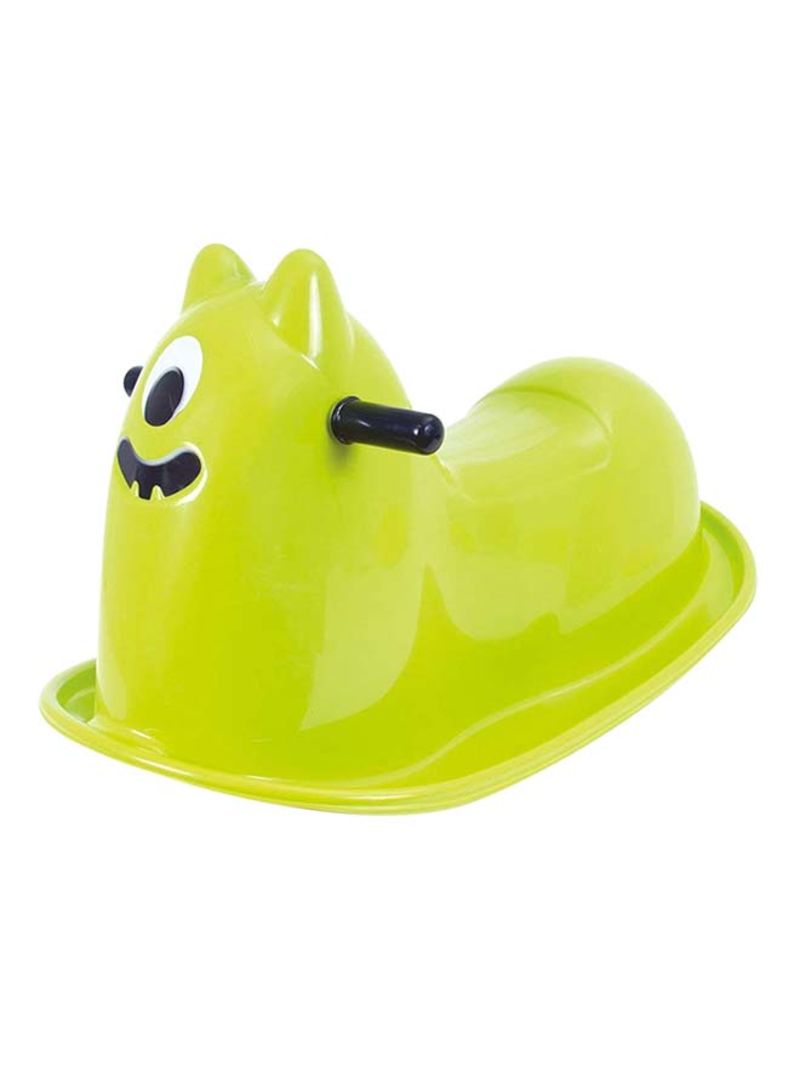 Bright green plastic rocker shaped like a friendly monster, featuring a single large eye, a smiling mouth, and two black handles for stability.
