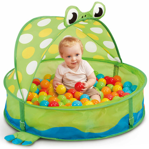 Bright green pop-up frog pool with a polka-dotted canopy, featuring a smiling frog face, filled with colorful plastic balls, and a toddler sitting inside.