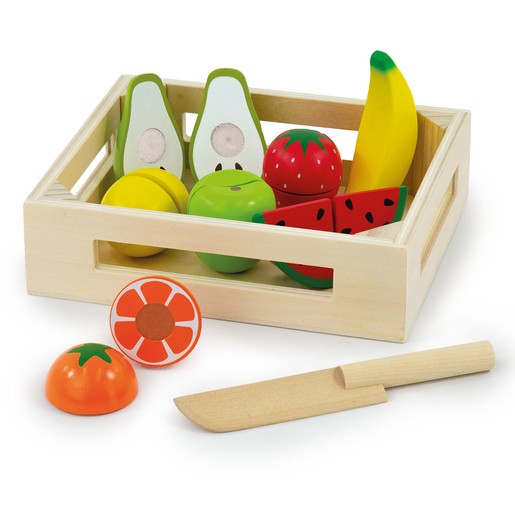 Wooden crate filled with colorful fruit toys including green avocados, red strawberries, a yellow banana, and a watermelon slice, accompanied by a wooden knife and a tomato.