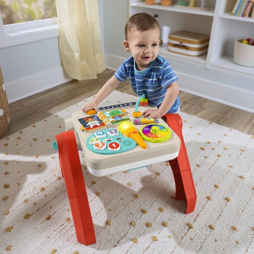 Colorful Fisher Price 4 in 1 Activity Table and Easel features interactive buttons, a musical keyboard, and sturdy red legs, with a child engaging with the various play elements.