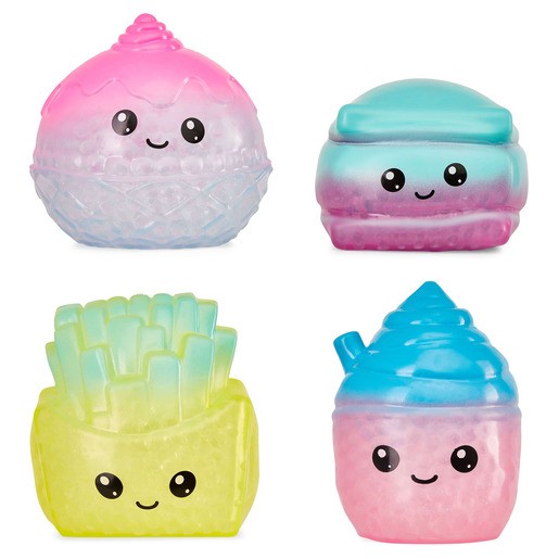 Four colorful squishy fidget toys featuring a smiling ice cream cone, a macaron, a container of fries, and a soft-serve ice cream, all in pastel shades and varying textures.