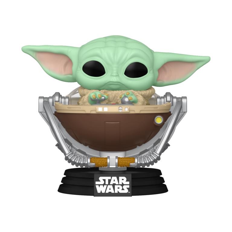 Grogu, a small green figure with large ears, sits in a brown pram with silver details, featuring a black base labeled "STAR WARS."