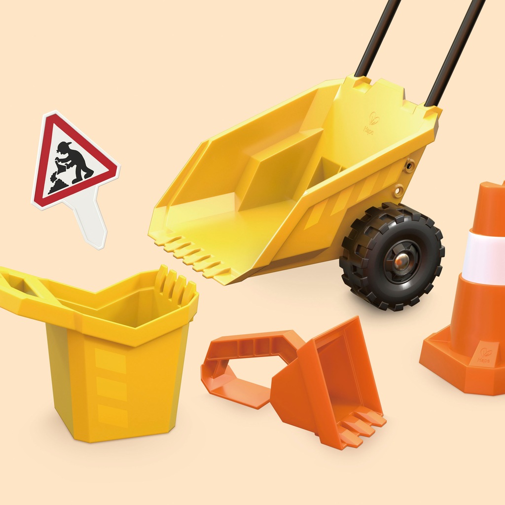 Bright yellow toy dump truck with black wheels, a matching bucket, an orange scoop, and a construction sign, all made of durable plastic for sand play.
