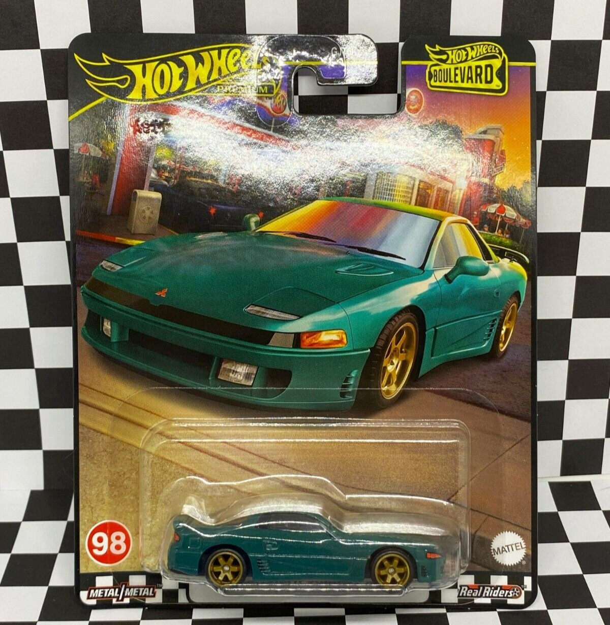 Teal Hot Wheels Boulevard Mitsubishi 3000GT VR-4 vehicle with gold rims, displayed in packaging featuring a colorful urban backdrop.
