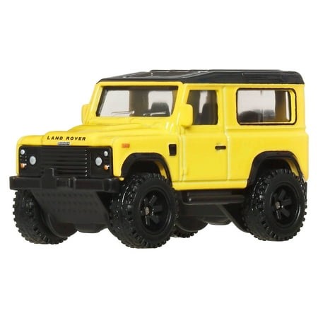 Bright yellow Hot Wheels Premium Off Road Land Rover Defender 90 with black wheels and accents, featuring detailed windows and rugged tires, designed for adventurous play.