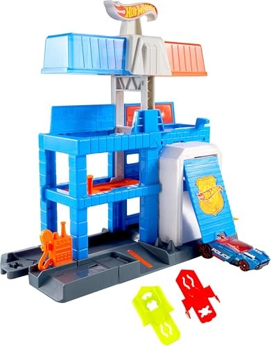 Colorful blue and gray police tower playset with multiple levels, featuring a ramp, a police car, and accessories, designed for imaginative play with Hot Wheels vehicles.