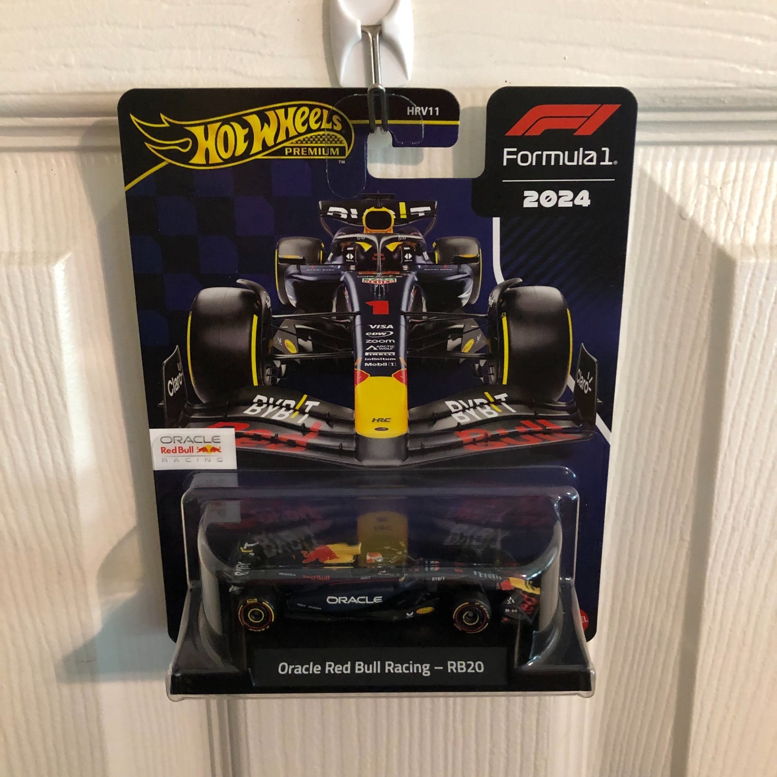 Black and yellow die-cast model of the Oracle Red Bull Racing F1 vehicle, featuring detailed sponsor logos and a sleek aerodynamic design, packaged on a branded card.