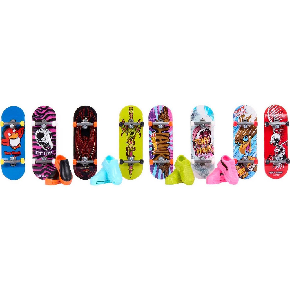 Colorful Tony Hawk-themed skateboards in various designs, featuring vibrant graphics, with two pairs of skate shoes in blue and pink.