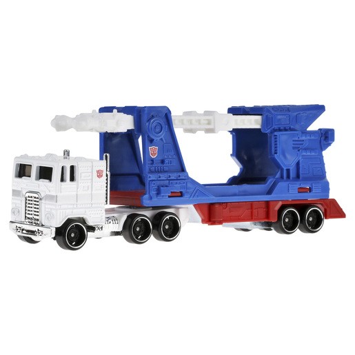 Hot Wheels Ultra Magnus vehicle features a white truck cab with black wheels and a blue and red trailer, showcasing a detailed design reminiscent of Transformers.