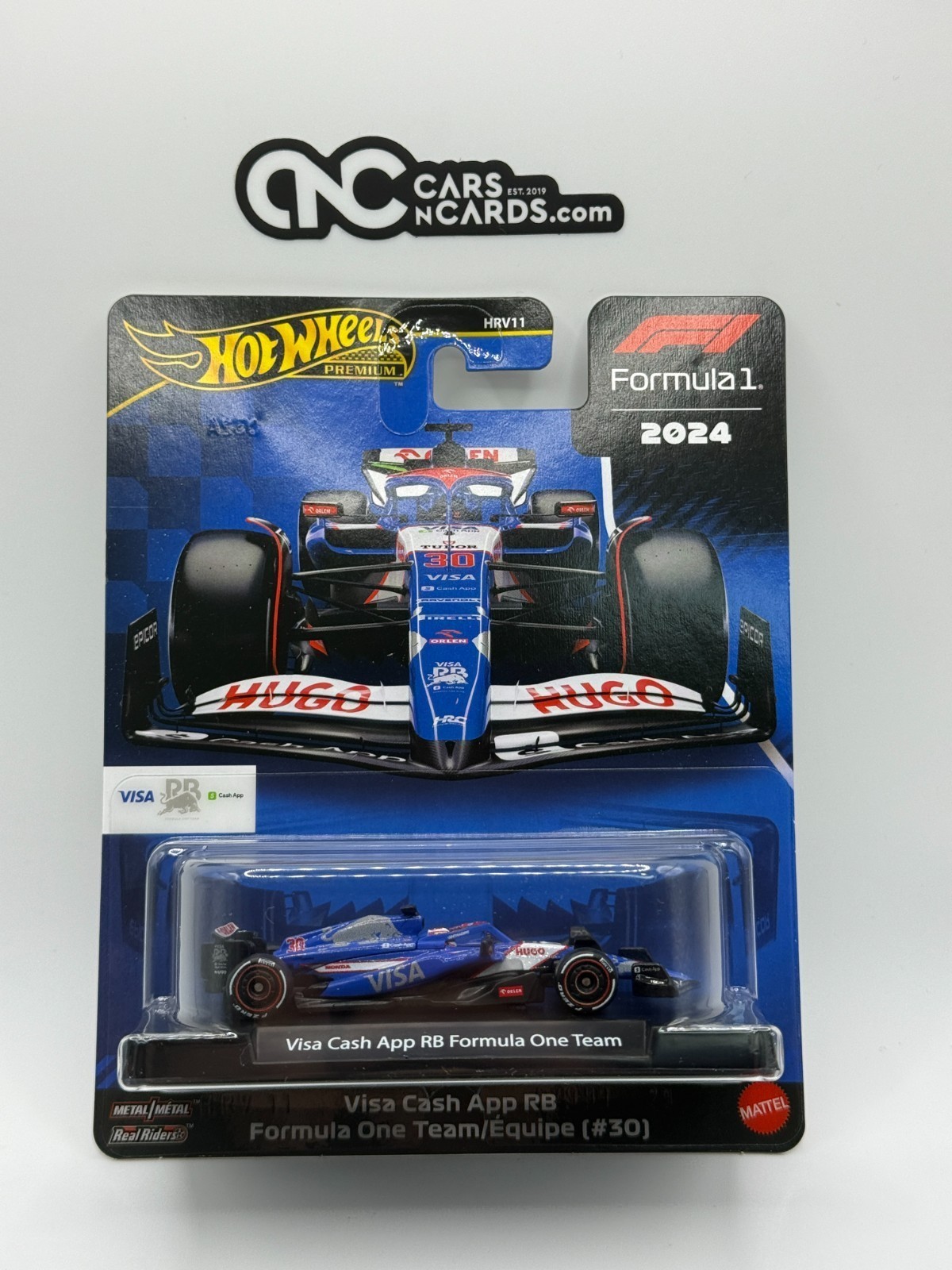 Blue and red Hot Wheels F1 vehicle with "Visa" branding, featuring a detailed design and sleek aerodynamic shape, displayed on a card with a vibrant racing theme.