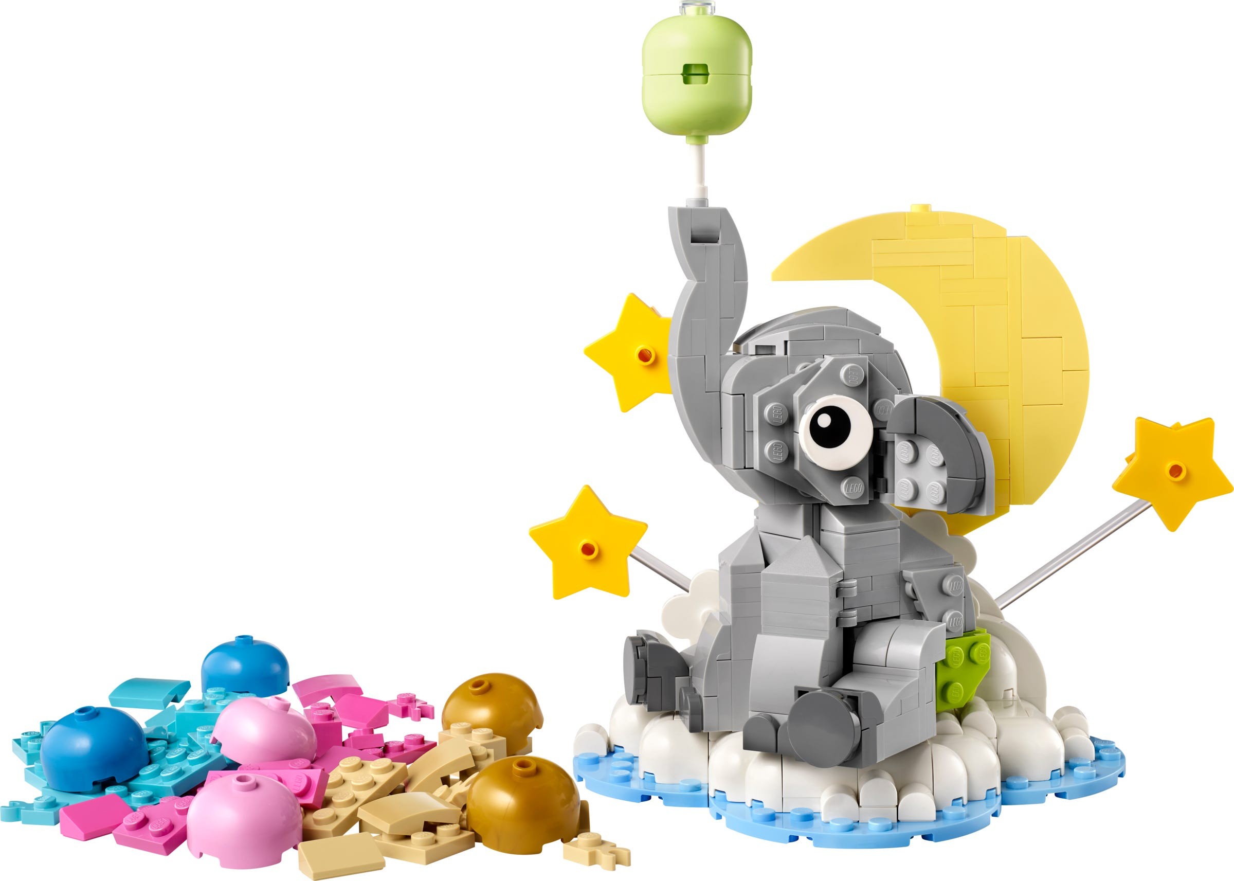 A colorful LEGO set featuring a gray baby elephant holding a green balloon, surrounded by pastel-colored building blocks and a crescent moon with stars.