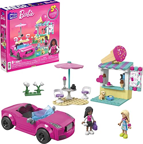 Bright pink convertible car with a clear windshield, two Barbie dolls, an ice cream stand with colorful awning, outdoor seating, and a small dog, all set against a vibrant box design.