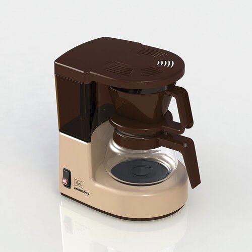 Beige Melitta Aromaboy coffee machine with a brown top, transparent glass carafe, and a simple control panel featuring an on/off switch.