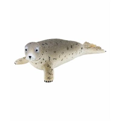 Realistic grey seal toy figure with a soft, textured surface, featuring a light grey body, dark spots, and detailed facial features including black eyes and whiskers.