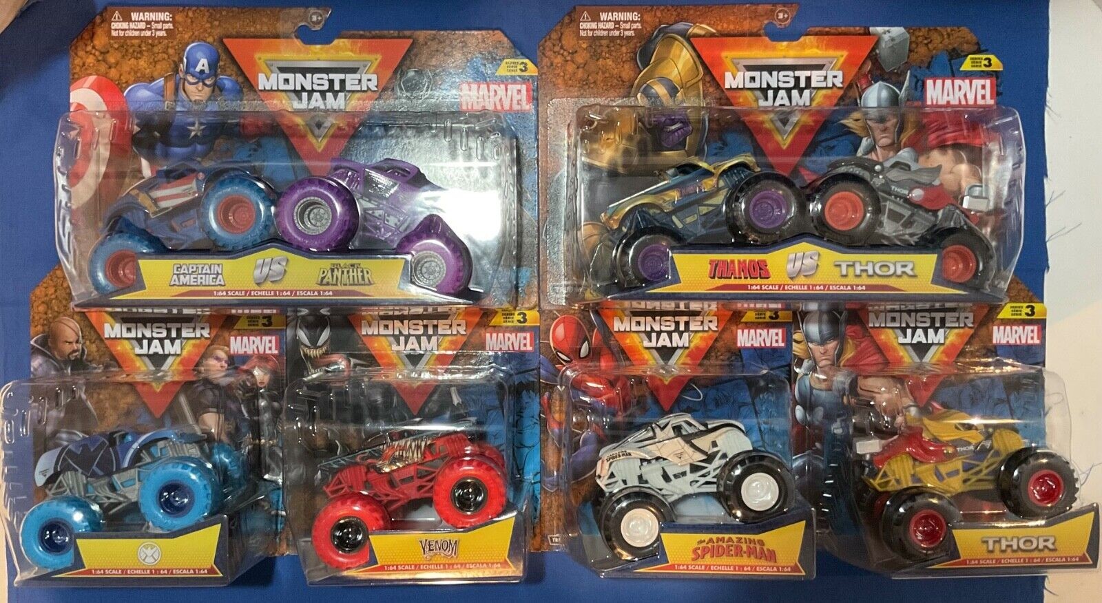 Two die-cast vehicles in a 1:64 scale pack featuring Captain America in blue and red and Black Panther in purple and black, both with detailed designs and Marvel branding.
