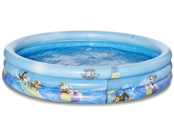 Round inflatable pool featuring a light blue color with Paw Patrol characters, measuring 100 x 23 cm, designed for children with vibrant graphics and water inside.