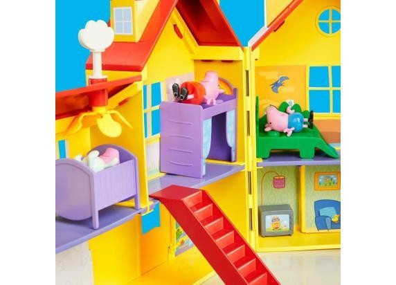 Brightly colored yellow playset featuring Peppa Pig's family house with red roofs, purple beds, a staircase, and small figurines of Peppa and friends inside.