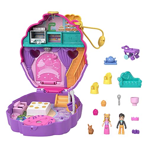 Bright purple cupcake-shaped compact playset with pink interior, featuring a kitchen, stairs, and various accessories including characters, furniture, and a pet rabbit.
