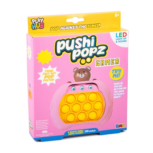 Bright pink packaging for "Pushi Popz Bear Gamer," featuring a bear character, LED lights, and a fidget game with 10 colorful buttons, designed for ages 6 and up.