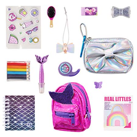 A vibrant pink mini backpack and handbag set featuring glittery accents, a holographic pouch, colorful stationery items, and playful accessories like stickers and a hairbrush.