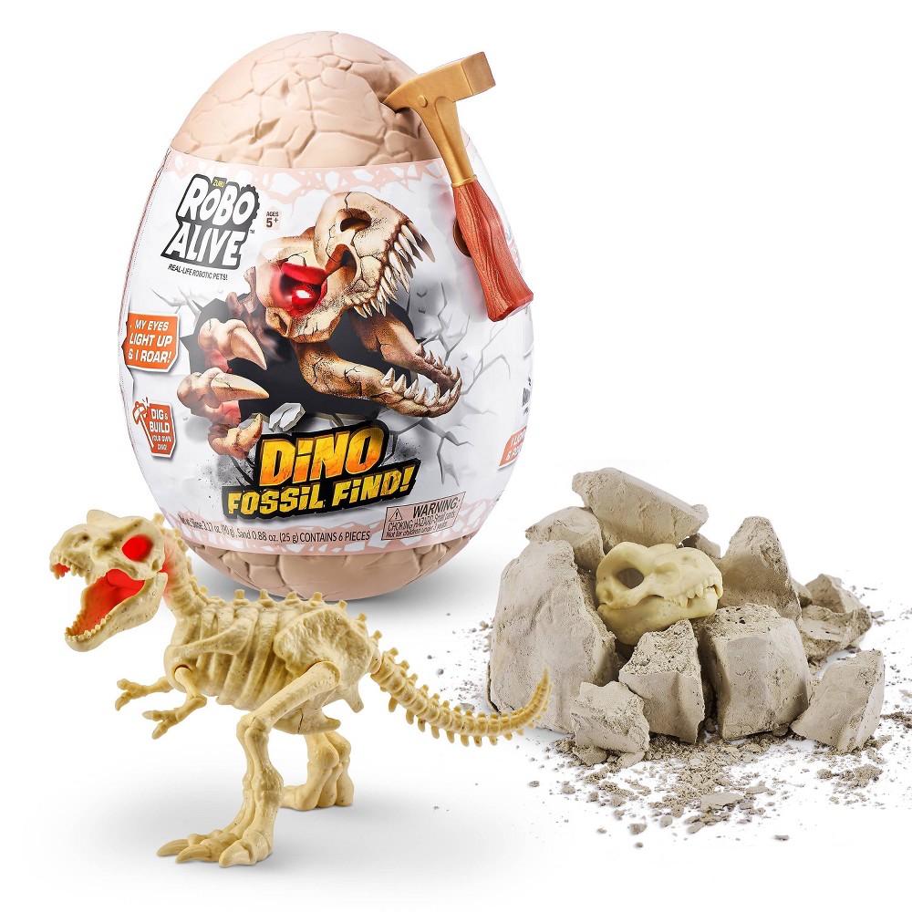 A large pink egg with a cracked top, a small hammer, and a robotic dinosaur skeleton emerging from gray excavation material, featuring glowing red eyes and a detailed skull.
