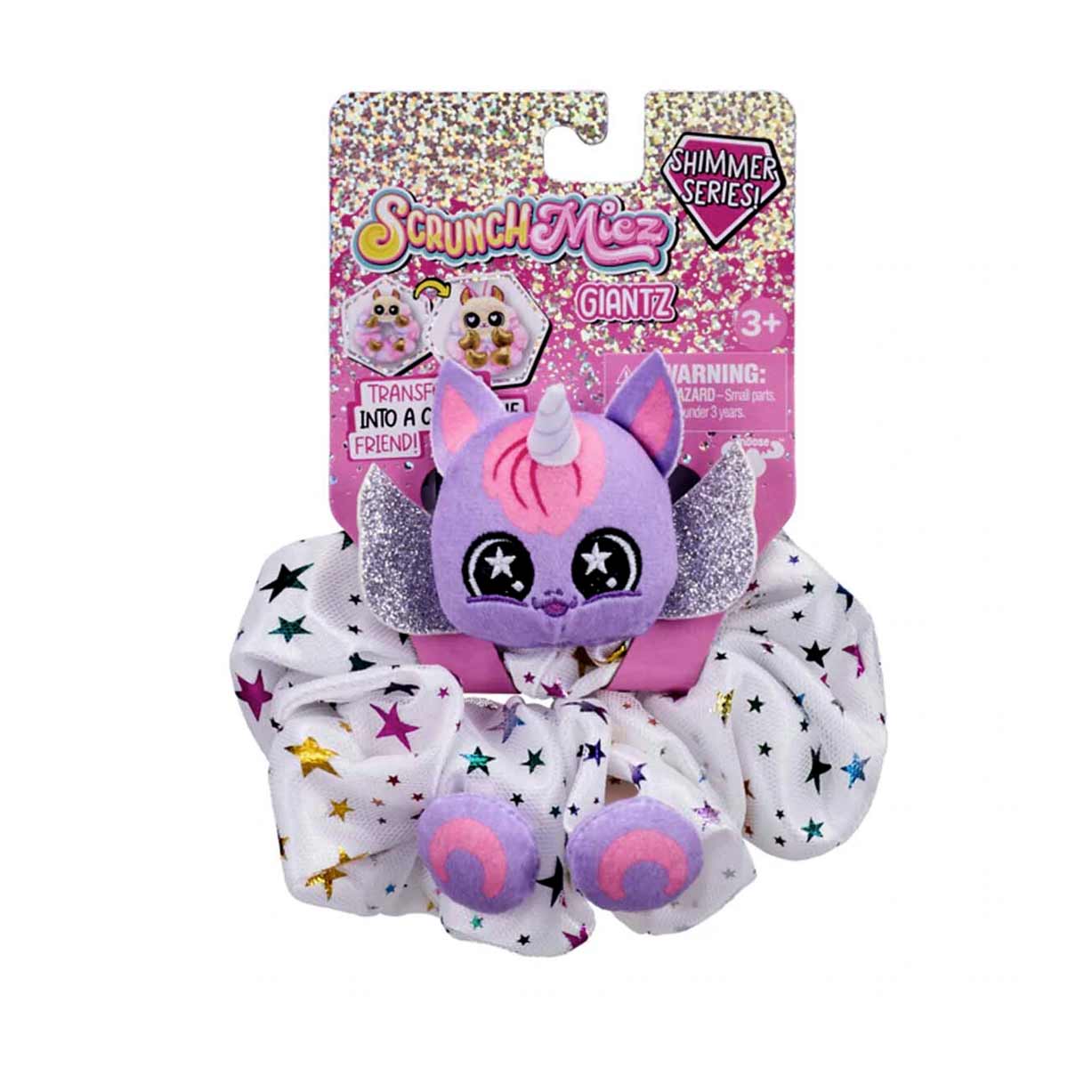 Purple unicorn plush with glittery ears and a pink horn, attached to a white scrunchie adorned with colorful stars, packaged in a vibrant card with "ScrunchMiez Giantz" branding.
