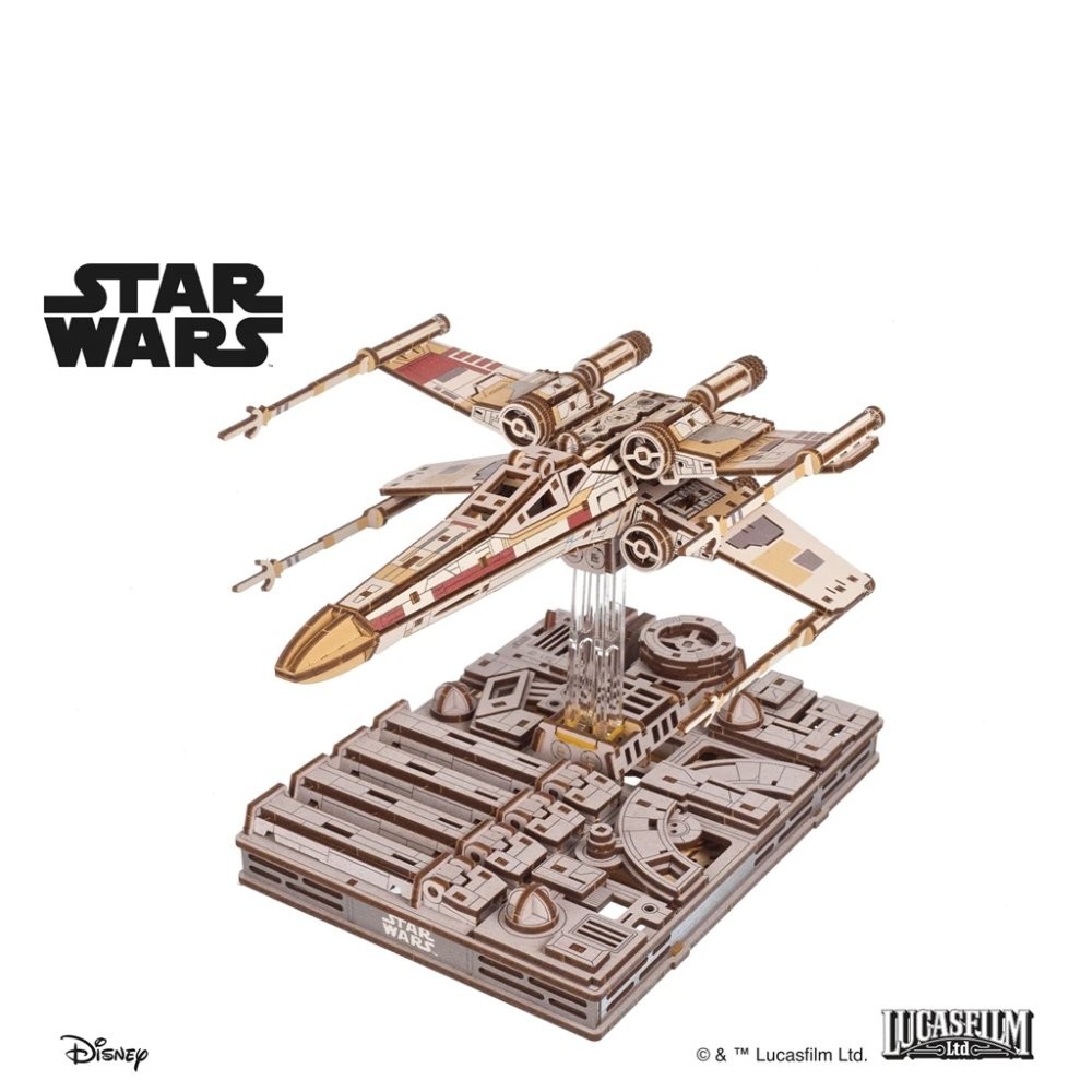 Detailed wooden 3D puzzle of Luke Skywalker’s X-Wing fighter, featuring intricate laser-cut designs, a beige and red color scheme, and a sturdy base with Star Wars branding.