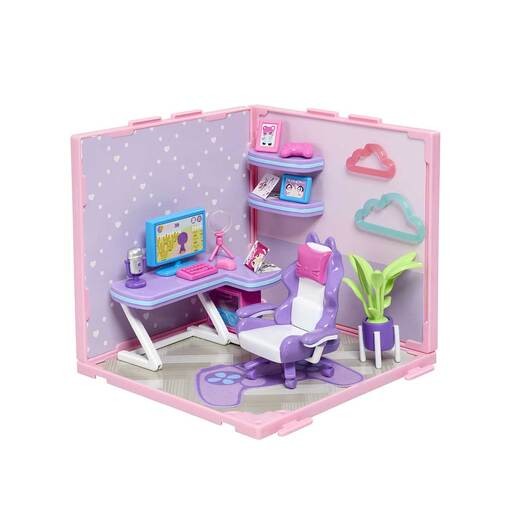 A colorful gamer room playset featuring a purple and white gaming chair, a desk with a computer, shelves, decorative clouds, and a potted plant against a pink and purple backdrop.