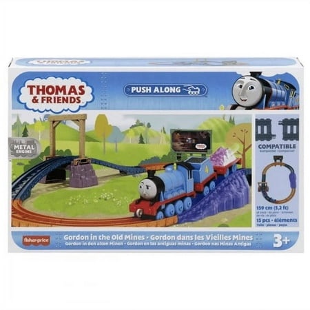 Thomas & Friends Gordon playset features a blue train with a smiling face, a metal bridge, and colorful track pieces, set against a vibrant mine-themed background.