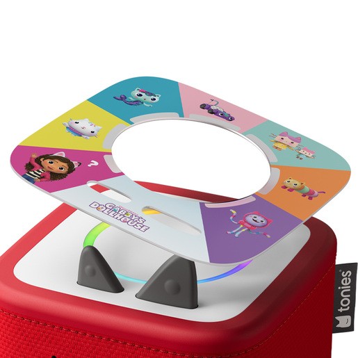 Colorful game board featuring Gabby's Dollhouse characters, set on a red Toniebox with a circular cutout, designed for interactive scavenger hunts.
