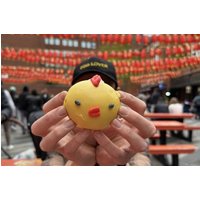 Asian Street Food Treasure Hunt guidebook with colorful market scene and vibrant street decorations in London.