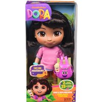 Dora Sing & Explore Doll in pink shirt, purple shorts, with backpack, in colorful box with music feature highlights.