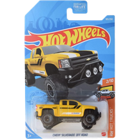 Yellow Hot Wheels 1:64 Chevy Silverado Off Road with black accents, large tires, and rugged design in packaging.