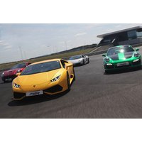 Yellow Lamborghini, green Porsche, and other sports cars on a racetrack, part of a junior driving experience package.