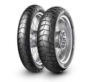 Two METZELER "Karoo Street" motorcycle tires with a rugged tread pattern, featuring a black rubber surface and silver rims, designed for both on-road and off-road performance.