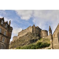 Murder Mystery Experience package featuring Edinburgh Castle with historic stone architecture and lush greenery.