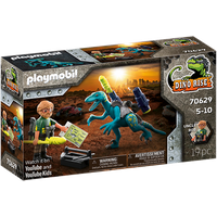 Playmobil Dino Rise set with blue Deinonychus, figure with goggles, and accessories in a detailed box.