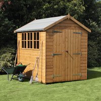 Wooden garden shed with shiplap cladding, apex roof, large double doors, and side windows, set on a grassy lawn.