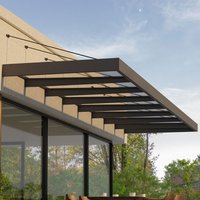 Grey clear door canopy with metal frame, slanted roof, and transparent panels, by Palram Canopia, 7.5m x 1.4m.