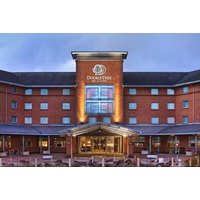 DoubleTree by Hilton Glasgow Strathclyde, red brick facade, large entrance, illuminated signage, evening setting.