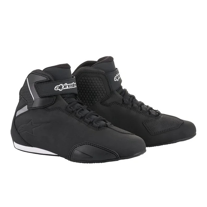 Black and white Alpinestars Sektor shoes, size 7 US, featuring a sleek design, lace-up front, padded ankle support, and textured side panels for enhanced grip.